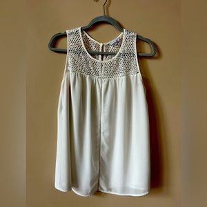Off white dressy tank with white woven design around the neck and chest.